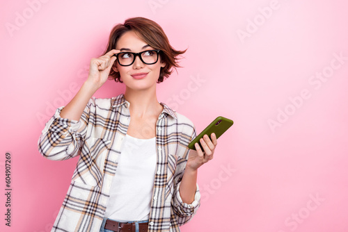 Fotobehang Portrait of thoughtful clever business lady wear plaid shirt smartphone looking