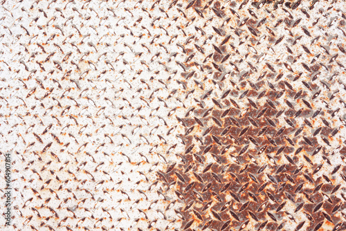 Steel corrugated sheet close-up. The bulges are lentil-shaped. Half of the surface is heavily worn. Visible rust. Background. Texture. photo