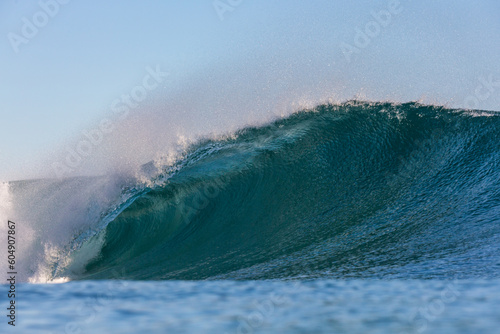 perfect wave breaking on a coral reef