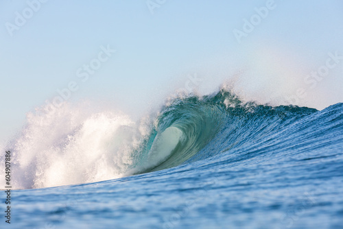 massive powerful wave breaking on a shallow reef in the ocean
