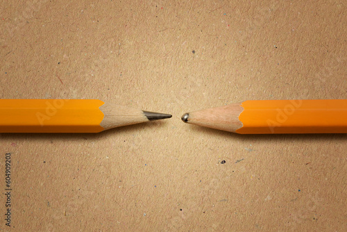 Sharpened pencil versus dull pencil on recycled paper background - Concept of innovation and creativity photo