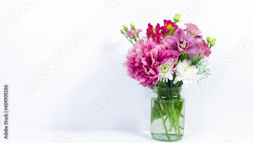 Wallpaper Mural Bouquet of various natural flowers in a glass jar appears on a white background. Greeting card for birthday, mother's day, women's day or other occasion. Stop motion animation. Copy space. Torontodigital.ca