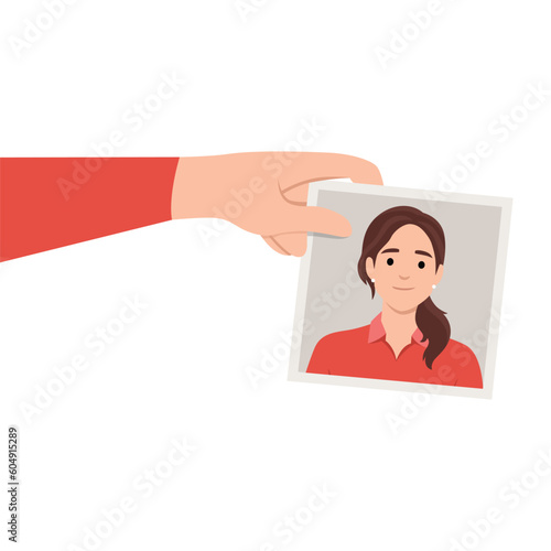 Illustration of a hand holding a photo of a woman smiling.