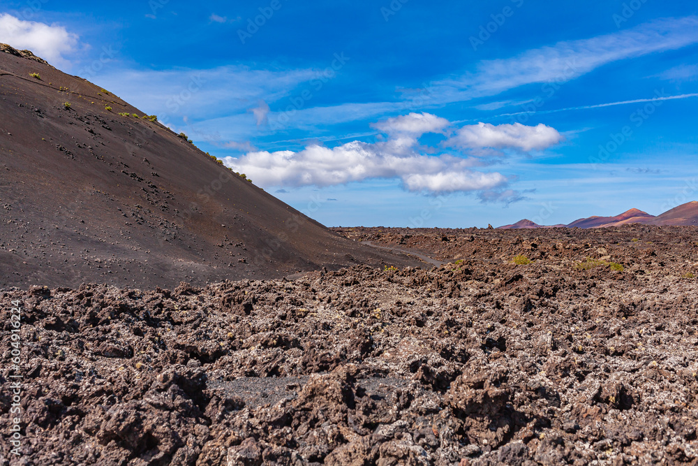 Lava of an extinct volcano in a valley on the Canary Island. Volcanic coast. Tourism.