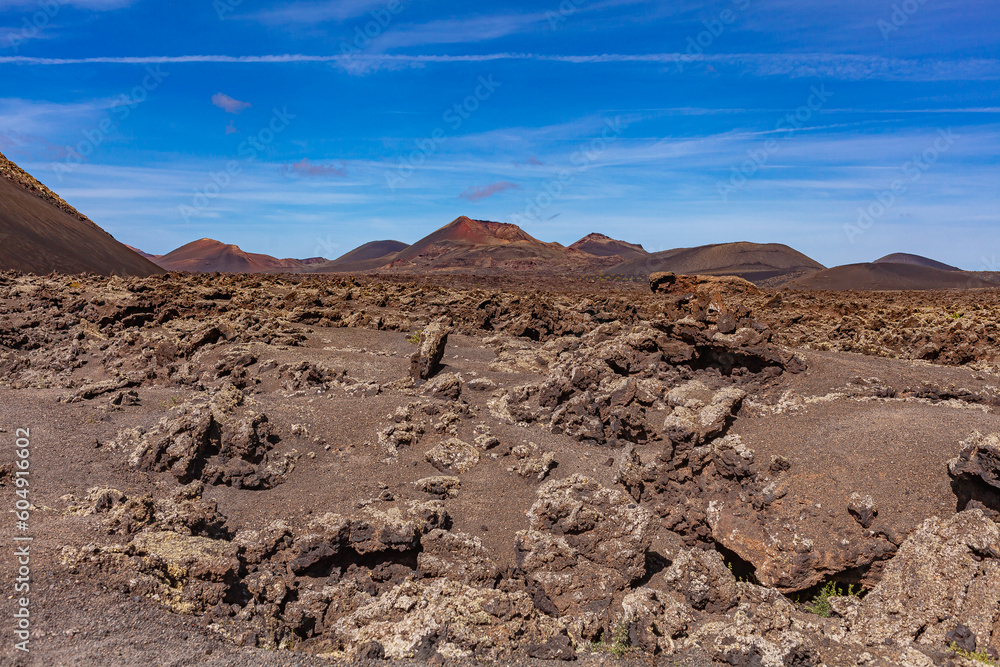 Volcanic landscape. The crater of an extinct volcano in a valley on the Canary Island. Tourism.