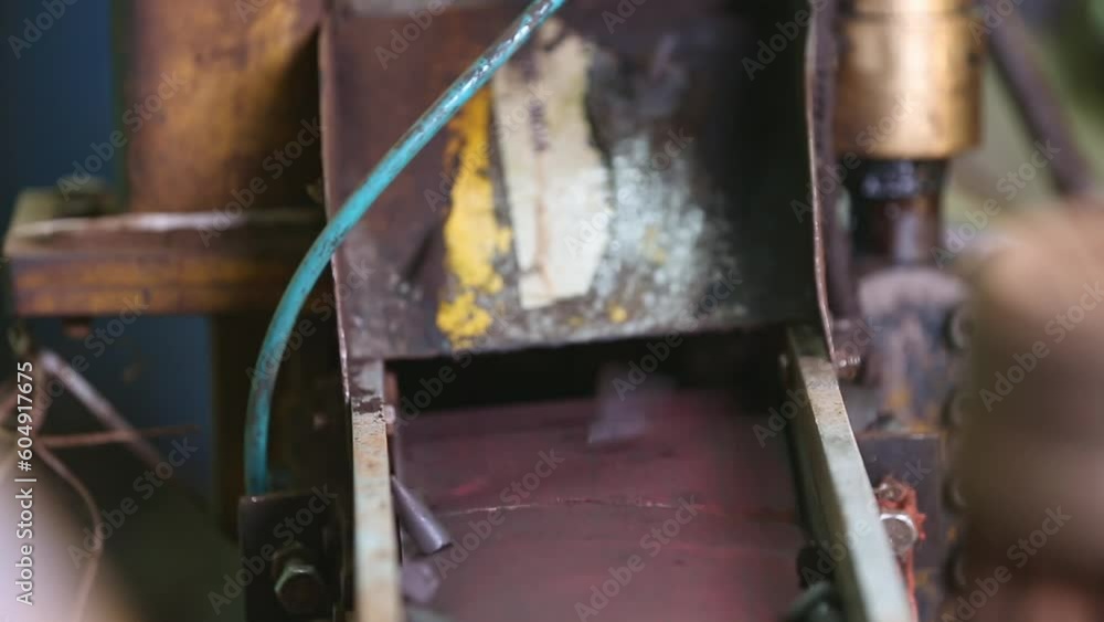 A closeup of manufactured or moulded incense cones dropping on a conveyor belt A closeup of manufactured or moulded incense cones dropping on a conveyor belt