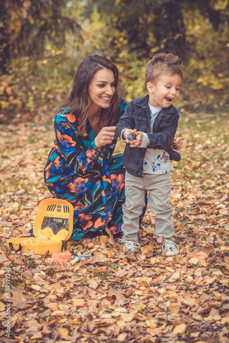 Happy smiling beautiful family playing and laugh in the forest