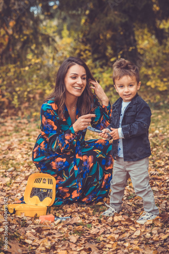 Happy smiling beautiful family playing and laugh in the forest