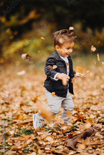 Child in the forest smiling and playing