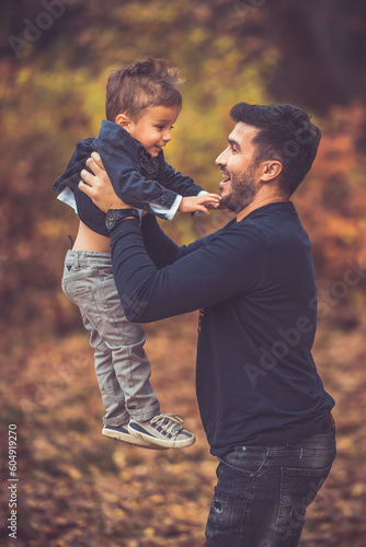 Happy smiling beautiful family playing and laugh in the forest
