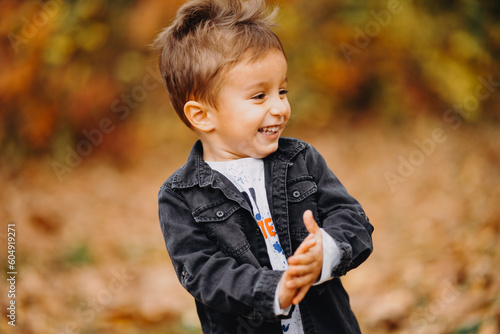 Child in the forest smiling and playing