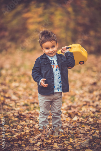 Child in the forest smiling and playing