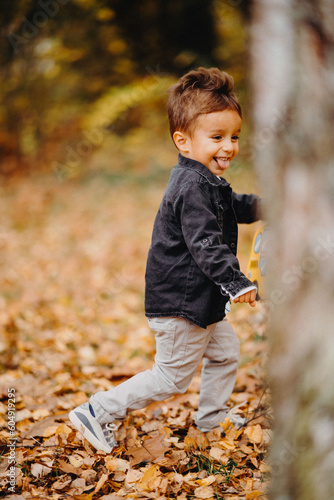 Child in the forest smiling and playing