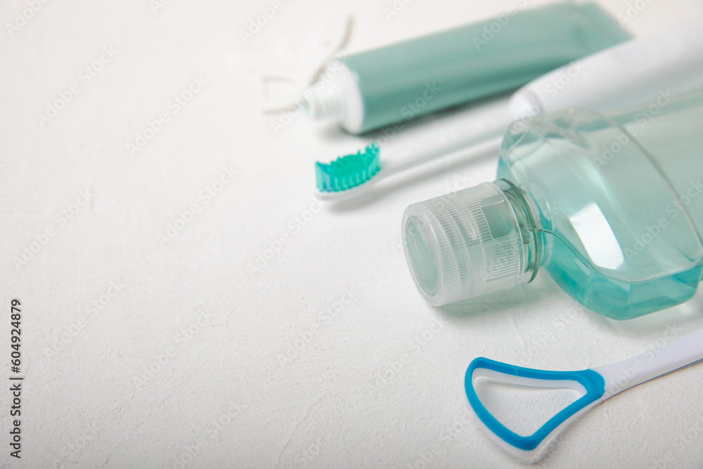 Bathroom with sonic electric toothbrush, toothpaste, mouthwash, dental floss and tongue cleaner . Oral hygiene. Dental care.Dentistry concept.Place for text.Place for copy.MOCKUP Bathroom with sonic electric toothbrush, toothpaste, mouthwash, dental floss and tongue cleaner . Oral hygiene. Dental care.Dentistry concept.Place for text.Place for copy.MOCKUP
