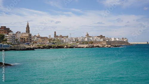 rocky coastline, turquoise sea and panoramic view of old town of picturesque Monopoli, Puglia, Italy