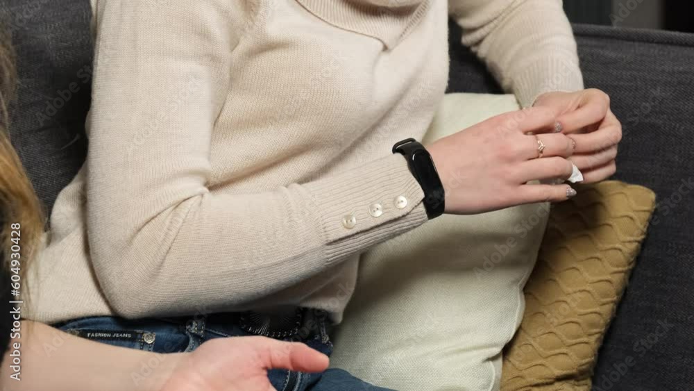 Girlfriend feels anxious and nervous during therapy with psychologist. Lady picks up napkin with fingers squeezing in therapist office Girlfriend feels anxious and nervous during therapy with psychologist. Lady picks up napkin with fingers squeezing in therapist office