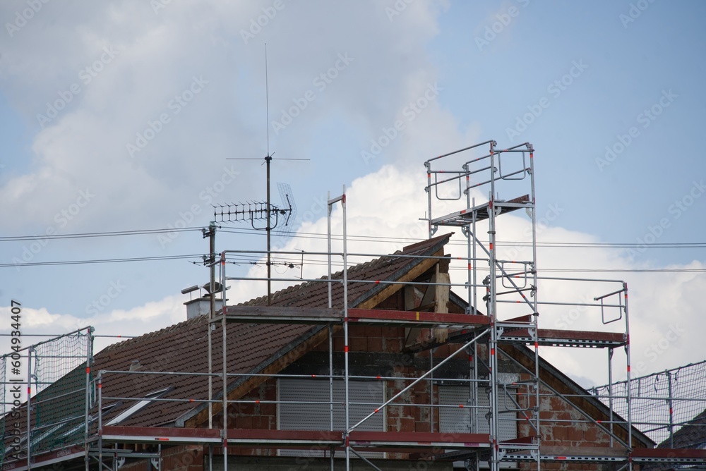 Residential house behind scaffolding - energetic renovation Residential house behind scaffolding - energetic renovation