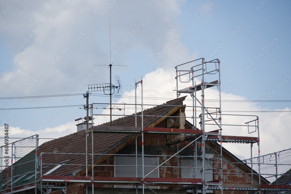 Residential house behind scaffolding - energetic renovation