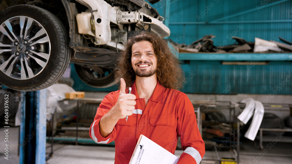Caucasian man in mechanic suit Standing in the garage, thumbs up, showing confidence in repairing cars for customers to meet the quality standards of the garage. to make customers satisfied
