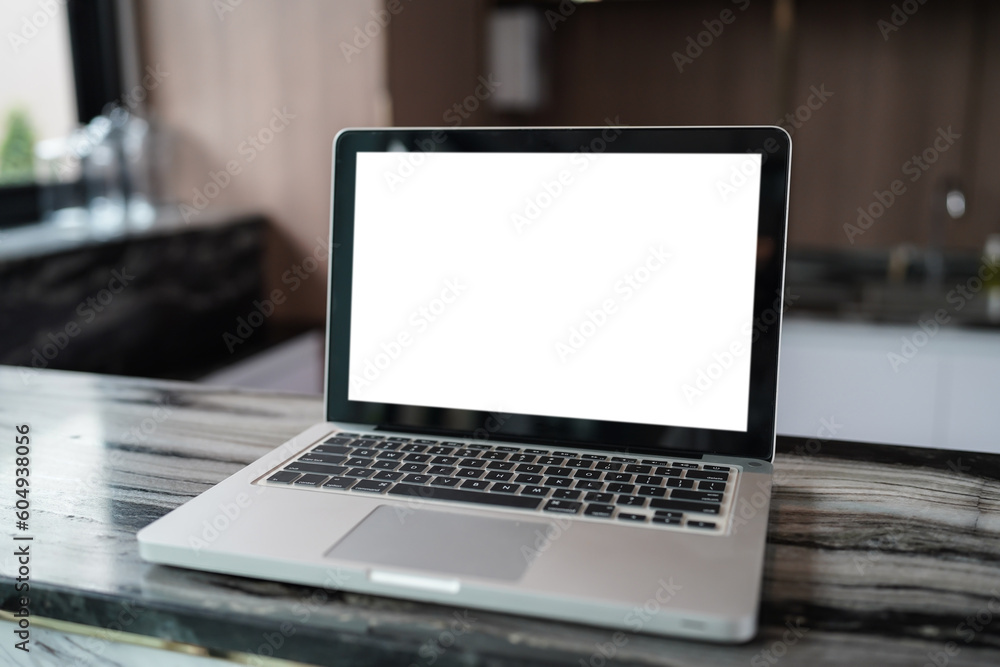 Fototapeta premium Laptop with Mock up blank screen on table in front of cafe space for text. product display computer laptop montage- technology concept