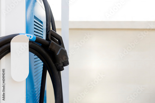 electric car charging station at outdoor parking place with soft-focus and over light background