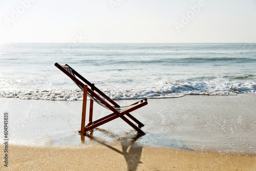 An empty chair on the beach.