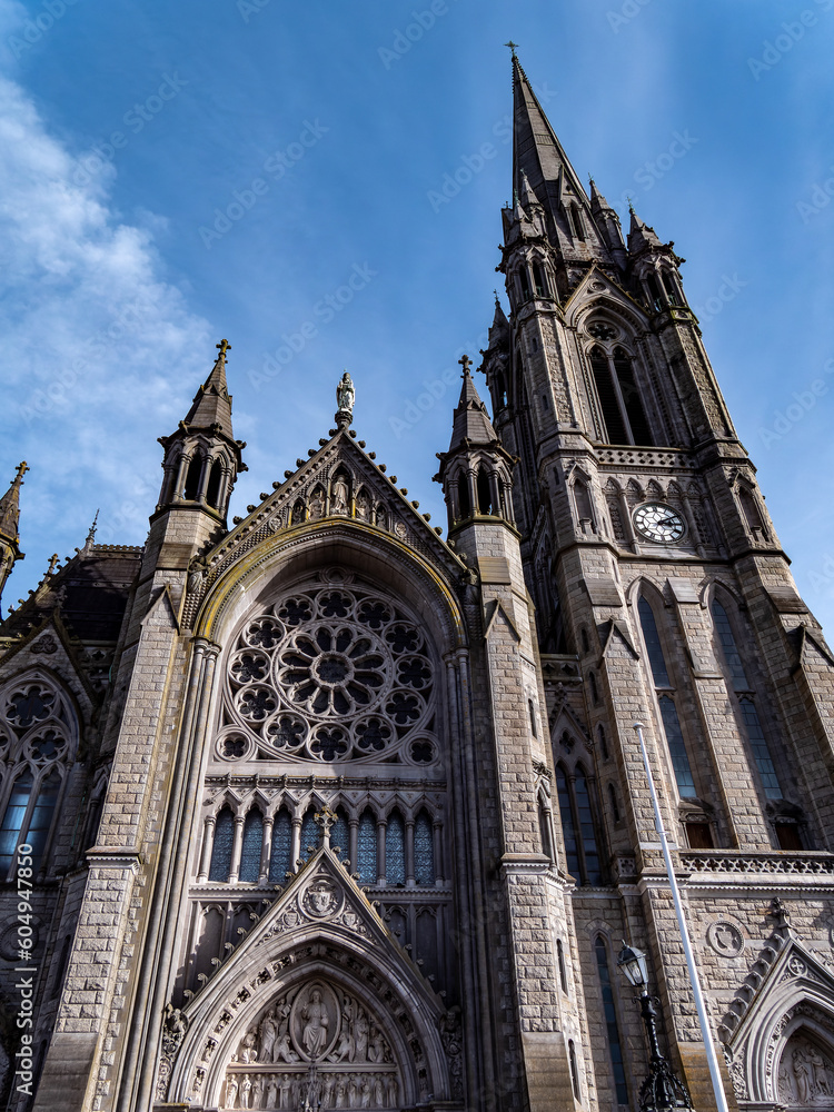 Fototapeta premium Catholic Cathedral in Ireland, Gothic style. The Cathedral Church of St Colman known as Cobh Cathedral, or Queenstown Cathedral, single-spire cathedral in Cobh, Ireland.