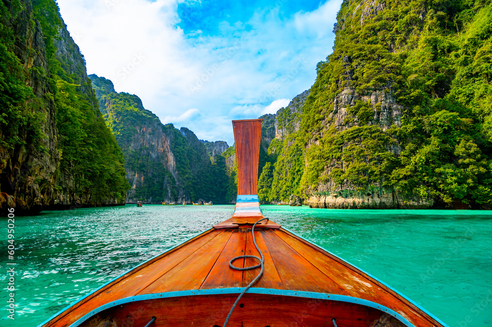 View of Pi Leh lagoon (also known as Green Lagoon) at Ko Phi Phi islands, Thailand. View from typical long tailed boat. Typical Thai picture of tropical paradise. Limestone rock and turquoise water.