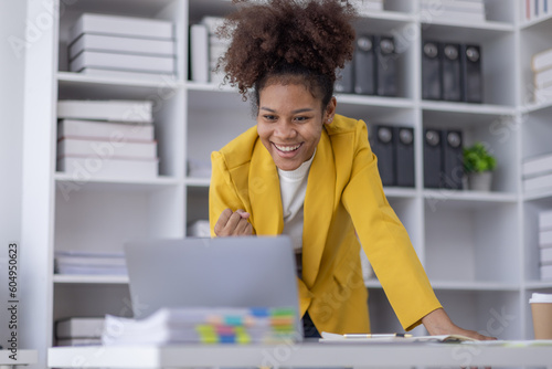 Excited african american woman sit at desk feel euphoric win online lottery, happy black woman overjoyed get mail at tablet being promoted at work, biracial girl amazed read good news at computer