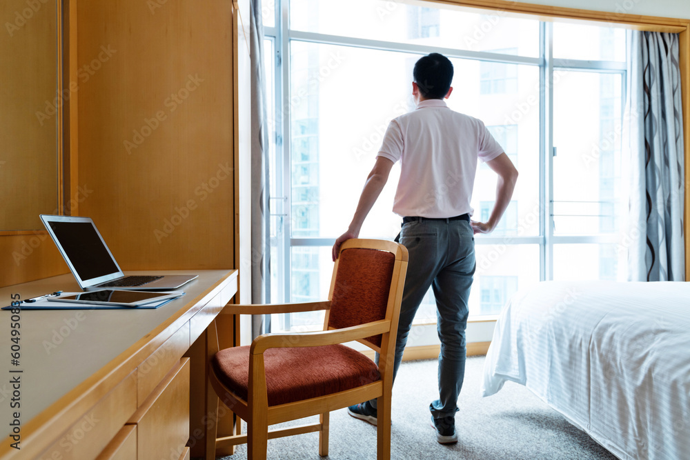 Man standing in front of the window Man standing in front of the window