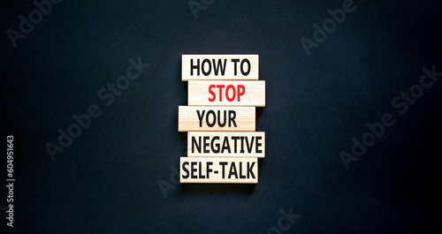 Stop negative self-talk symbol. Concept words How to stop your negative self-talk on wooden block. Beautiful black table black background. Psychological negative self-talk concept. Copy space