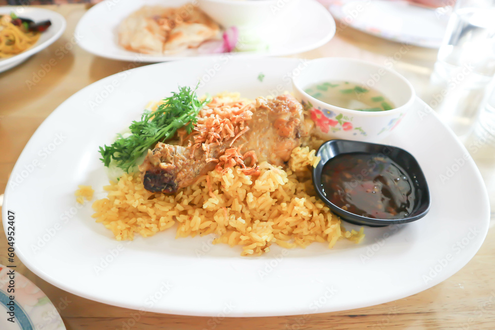 chicken rice or spiced rice steamed with chicken, rice topped with chicken chicken rice or spiced rice steamed with chicken, rice topped with chicken
