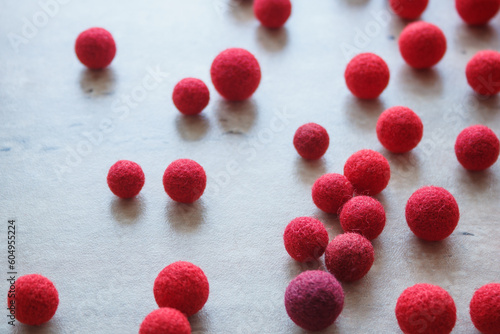 Red wool balls for needlework. © Roman