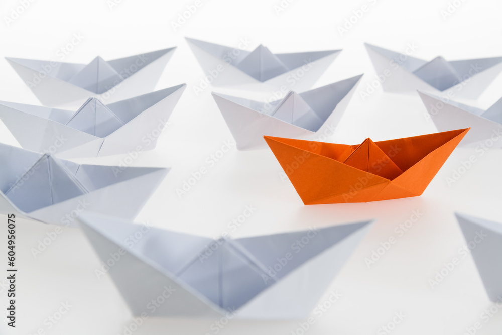 Orange paper boat stands out Orange paper boat stands out