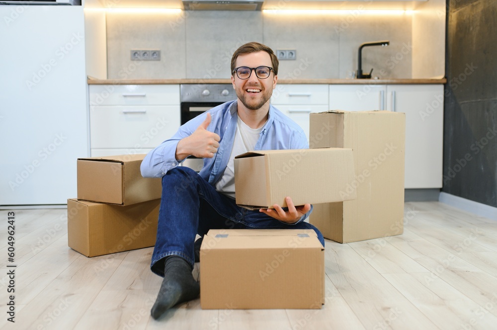 Smiling guy moving into his new home