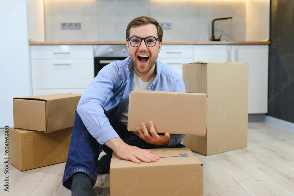 Smiling guy moving into his new home