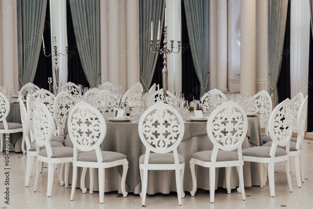 Served table for wedding ceremony, decorated with candles in the luxury restaurant.