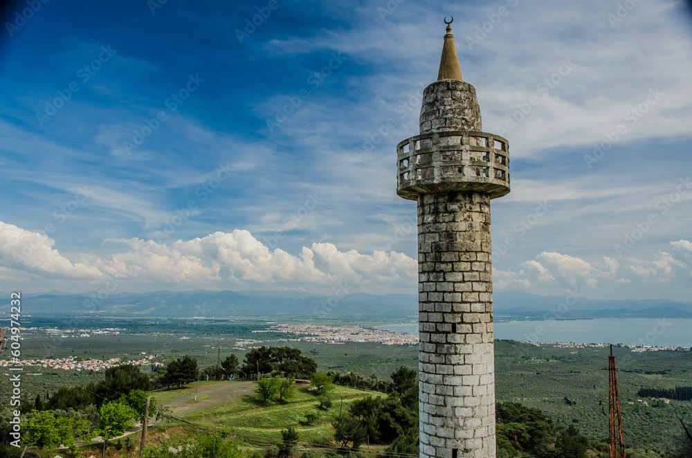 Obraz premium The only surviving structure among the destroyed houses of an abandoned village in Turkey. The minaret of a mosque.
