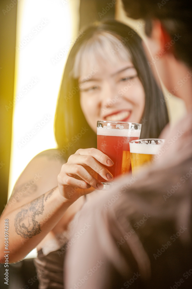 Happy couple toasting with beer at pub restaurant. Happy couple toasting with beer at pub restaurant.