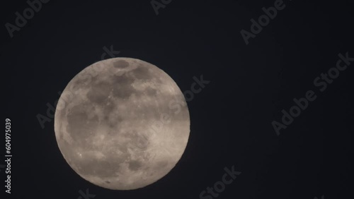 4k video of the full moon sliding very slowly up
