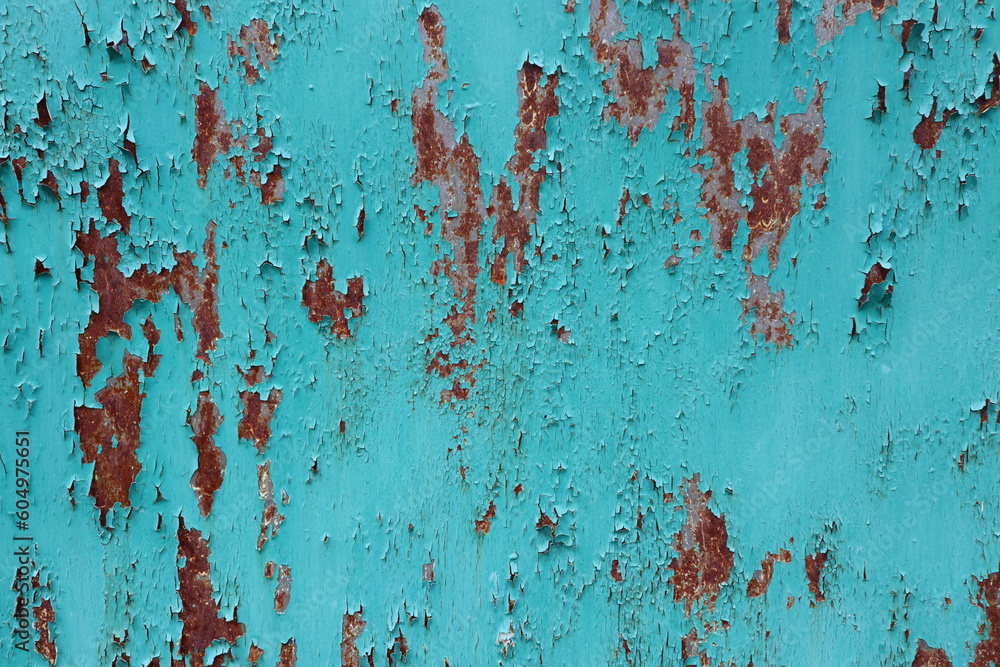 The wall is painted in a bright green color, and there is rust on the wall