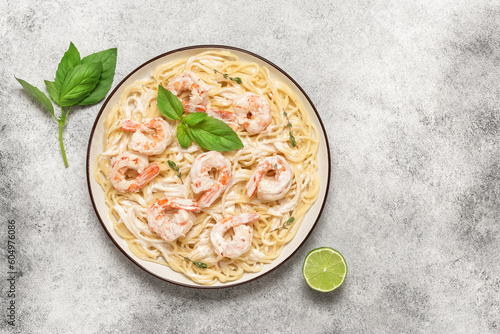 Spaghetti pasta with shrimps scampi on a light background. Top view, flat lay, copy space. Italian and mediterranean food.