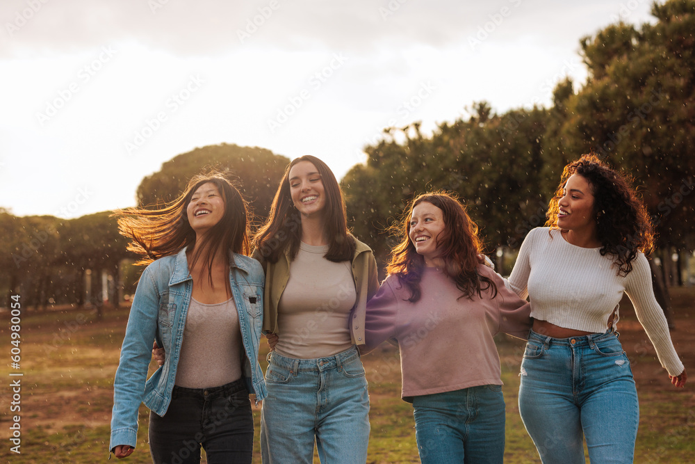 Four diverse young girl friends having fun while walking together. Four diverse young girl friends having fun while walking together.