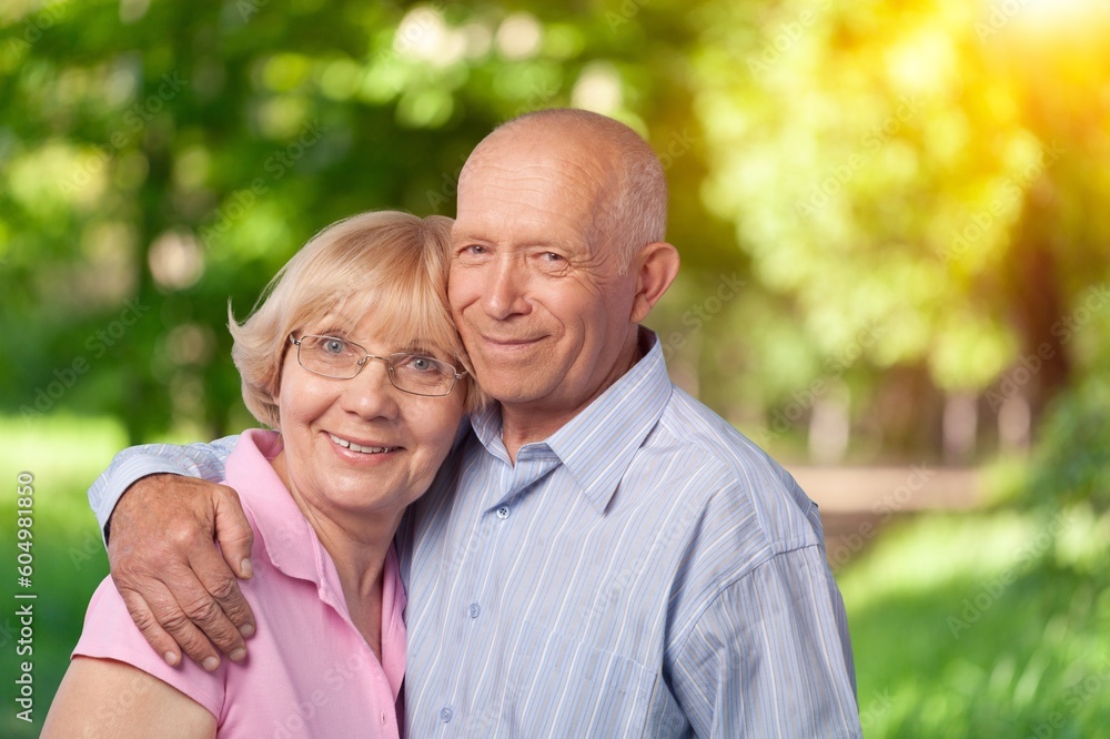 Portrait of old cheerful people walking in forest