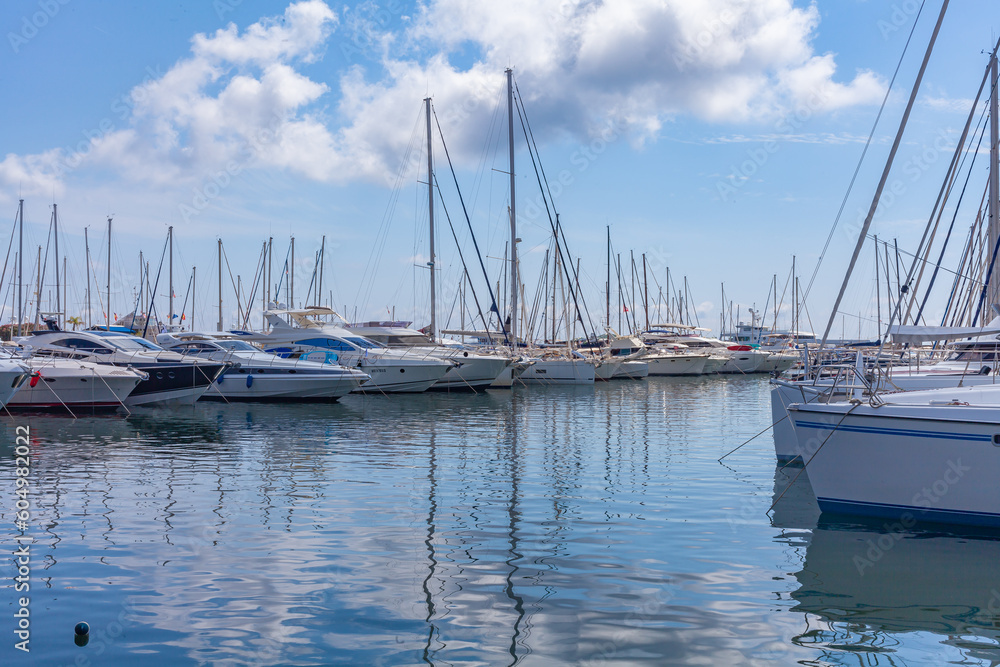 Panorama. Sea port. Yachts, boats, boats in sea bay. A clear sunny day with white clouds on horizon.