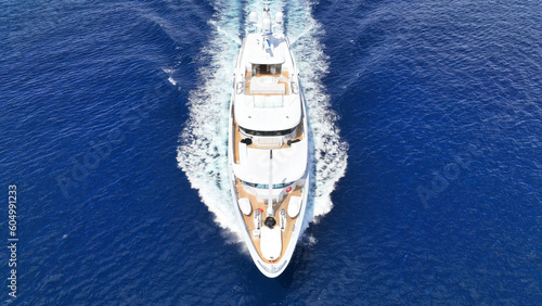 Aerial drone photo of luxury yacht with wooden deck cruising open ocean deep blue Aegean sea © aerial-drone