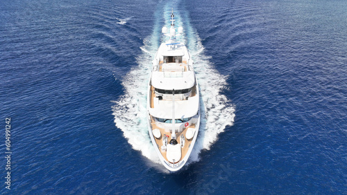 Aerial drone photo of luxury yacht cruising in deep blue Aegean sea