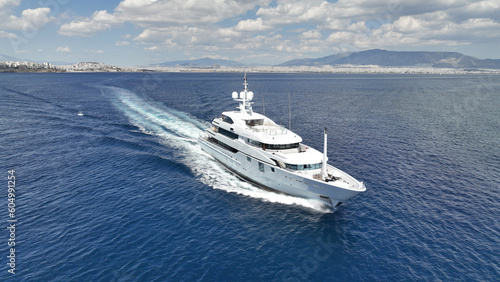 Aerial drone photo of luxury yacht with wooden deck cruising open ocean deep blue Aegean sea © aerial-drone