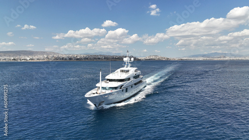 Aerial drone photo of luxury yacht cruising in deep blue Aegean sea