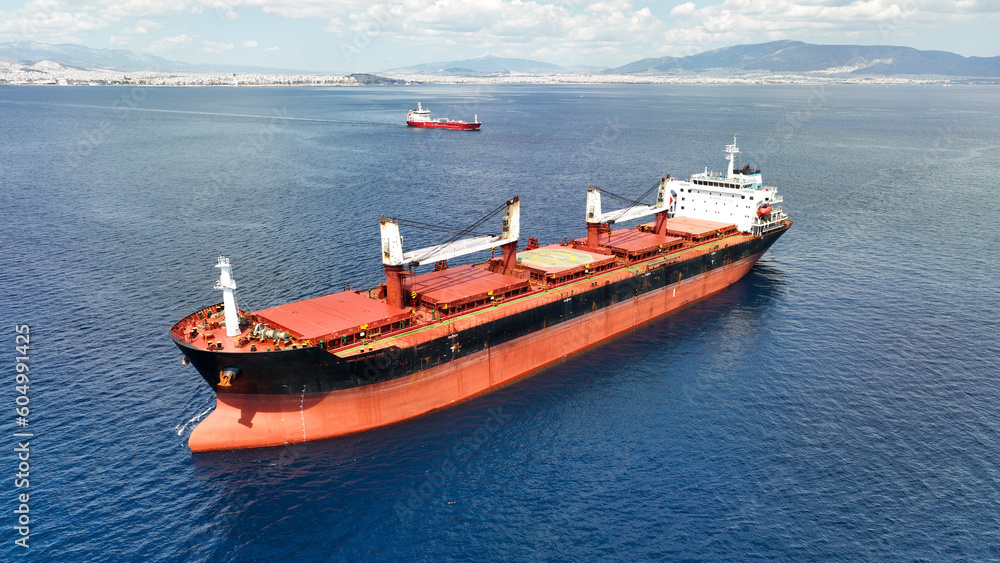 Fototapeta premium Aerial drone photo of huge bulk carrier tanker anchored in deep blue Aegean sea